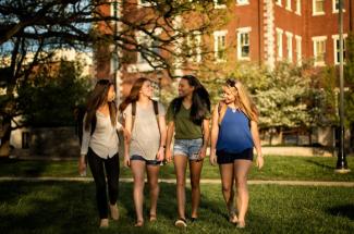 4 girls walking across UK campus