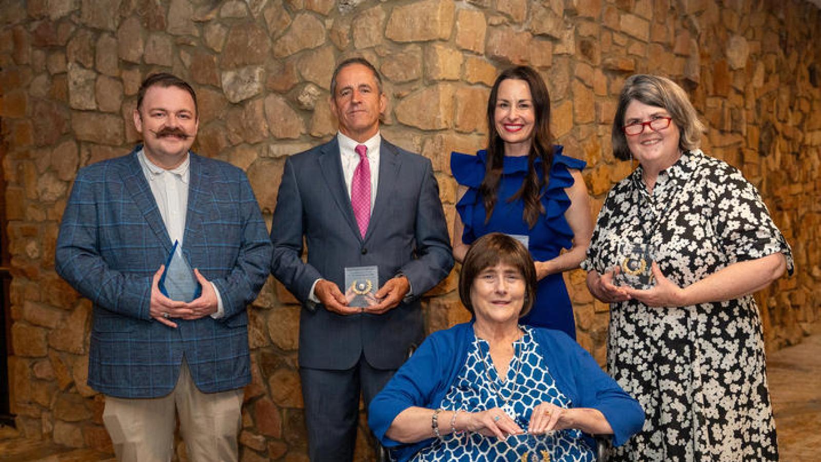 UK Alumni Association's Joseph T. Burch Young Alumni Award winner Zeb Vance (left) with the 2025 Distinguished Service Award winners (continuing from left) Phillip Elder, Rachel Watts Webb, Ouita Michel and (front) Tracy Lovan. Photo by Scott Hayes.