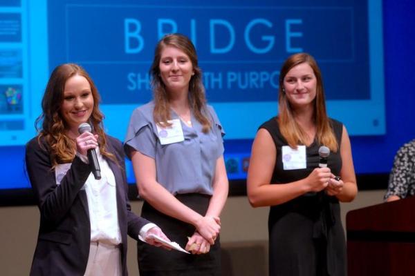 Taylor Wurth, Kristen McLaughlin and Megan Van Son make their presentation to a panel of investors.