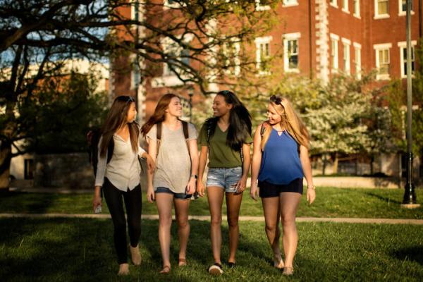 4 girls walking across UK campus