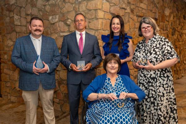 UK Alumni Association's Joseph T. Burch Young Alumni Award winner Zeb Vance (left) with the 2025 Distinguished Service Award winners (continuing from left) Phillip Elder, Rachel Watts Webb, Ouita Michel and (front) Tracy Lovan. Photo by Scott Hayes.