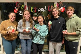 Honors Residential Experience Students Holding Decorated Cookies