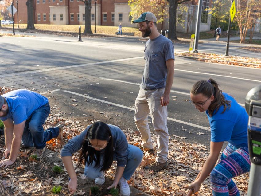 Dr. Kenton Sena with students planting